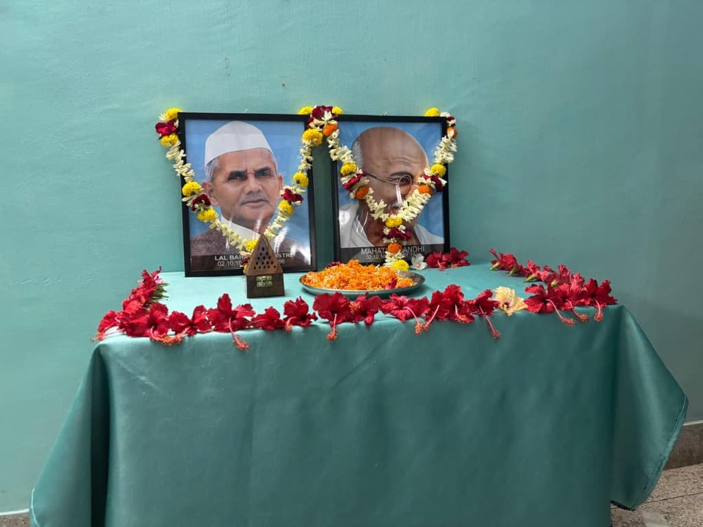Framed and garlanded portraits of Mahatma Gandhi and Lal Bahadur Shastri on commemorative table
